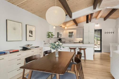 a kitchen and dining room with a wooden table and chairs at Shadow Mountain 20 in Aspen
