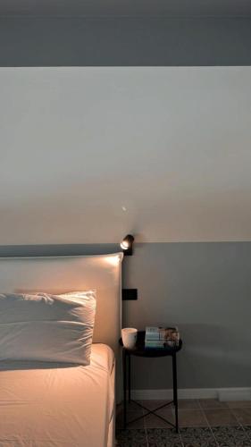 a bedroom with a bed and a side table with a lamp at Residenza Duca degli Abruzzi in Pescara
