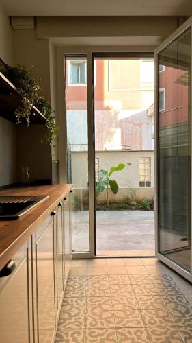 a kitchen with a large glass door to a courtyard at Residenza Duca degli Abruzzi in Pescara