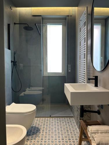 a bathroom with a sink and a toilet and a shower at Residenza Duca degli Abruzzi in Pescara