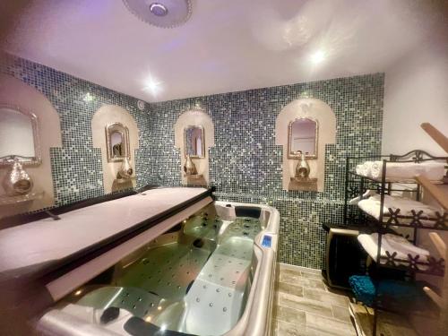 a bathroom with a tub and a sink at La Casa dei Sogni in Flayosc