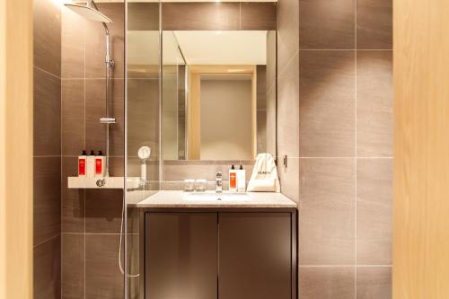 a bathroom with a sink and a shower at HOMES Red Myeongdong in Seoul