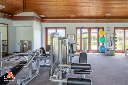 a gym with several tread machines in a room at 2BR bright quiet condo in Kulalani sleeps 6 in Waikoloa