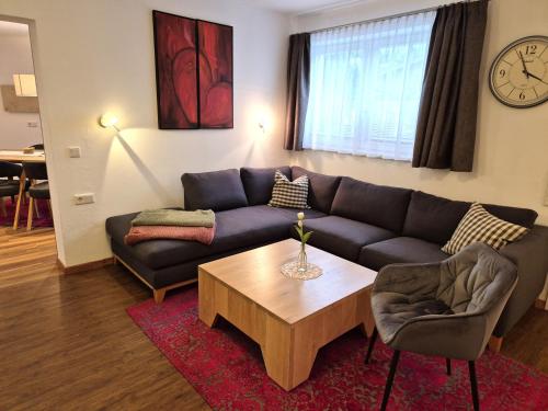 a living room with a couch and a coffee table at Ferienwohnung Simonhof in Maria Alm am Steinernen Meer