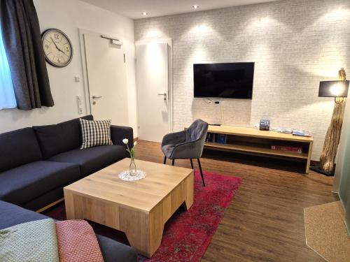 a living room with a couch and a coffee table at Ferienwohnung Simonhof in Maria Alm am Steinernen Meer