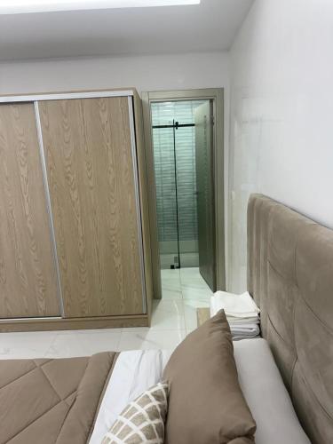 a living room with a couch and a closet at Appart Résidence Sabrin in Fnidek