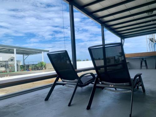 two chairs sitting on top of a building at The Moment Hostel Dulan in Donghe