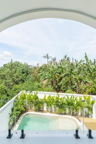 a view of a pool from the balcony of a resort at Charming 1BR Villa with Pool and Wooden Interior in Cemagi