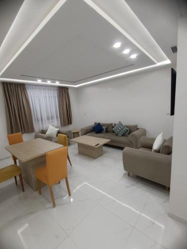 a living room with a couch and a table at Appart Résidence Sabrin in Fnidek