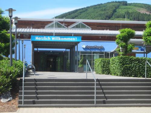 a building with a sign that reads harachi williamuments at City Pension in Plettenberg
