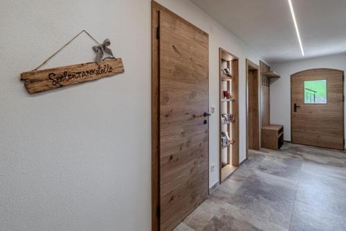 a hallway with a door and a sign that reads congratulations at Waltenberghof in Kitzbühel
