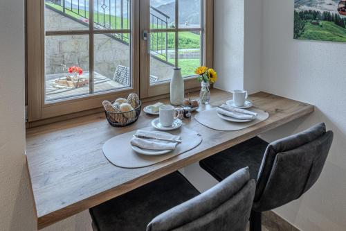 a dining room table with chairs and a table and a window at Waltenberghof in Kitzbühel