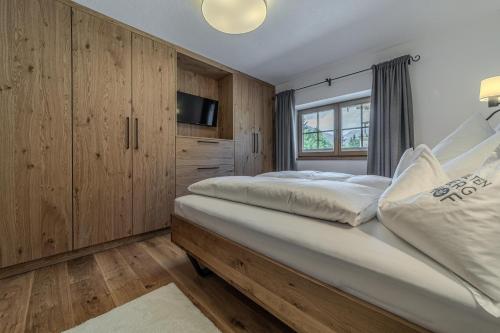 a bedroom with two beds and a tv at Waltenberghof in Kitzbühel