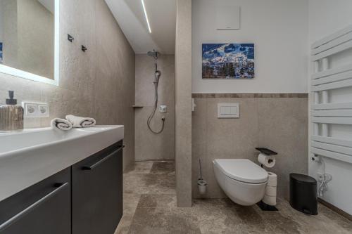 a bathroom with a white toilet and a sink at Waltenberghof in Kitzbühel