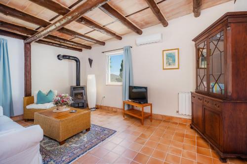 a living room with a couch and a tv at Individual Guesthouse Mallorca in Son Macia
