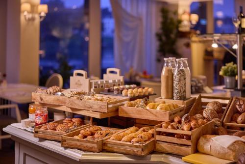 a display of different types of bread and pastries at Crowne Plaza Maastricht by IHG in Maastricht