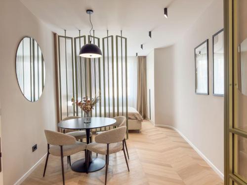 a dining room with a table and chairs at Historic Business Loft in Iaşi
