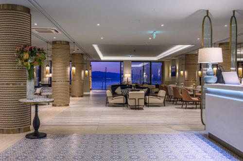 a lobby of a hotel with tables and chairs at Amadria Park Grand Hotel 4 Opatijska Cvijeta in Opatija