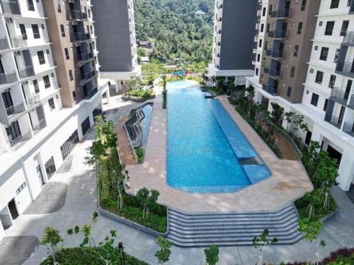 an overhead view of a swimming pool between two buildings at Family Suites Netflix House Aston Acacia Bukit Mertajam in Bukit Mertajam