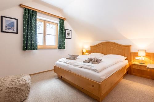 a bedroom with two cats laying on a bed at Apparthaus Sonnenberg in Haus im Ennstal
