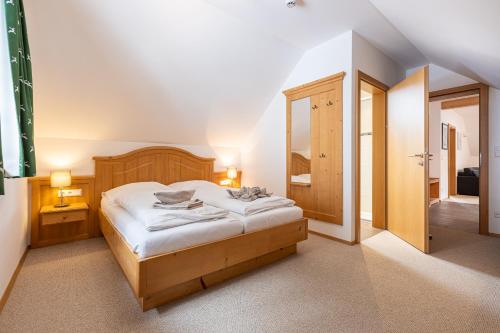 a bedroom with a large bed and a bathroom at Apparthaus Sonnenberg in Haus im Ennstal