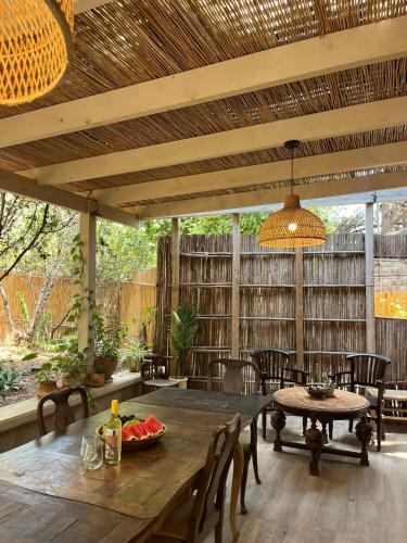 a patio with a wooden table and chairs at Beit Oren Hotel in Bet Oren