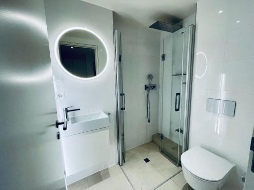 a bathroom with a toilet and a sink and a shower at Montreux Stunning 2 Bedroom Apartment Lake Geneva in Montreux