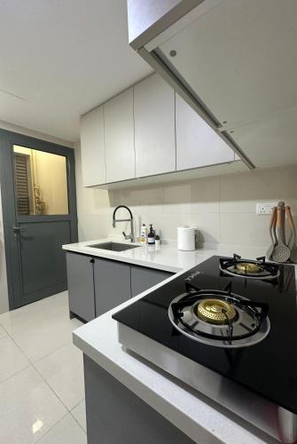 a kitchen with a black stove top in a kitchen at Boulevard Flat in Muscat