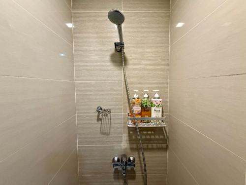 a shower with a shower head in a bathroom at Modern Suite In Bonifacio Global City in Manila