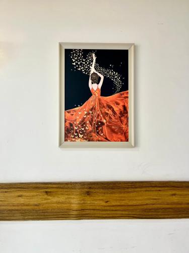 a picture of a woman in a red dress on a wall at Hotel Woodlark Zirakpur II A Peaceful Stay I Travelers Choice I Best for Family and Group in Chandīgarh