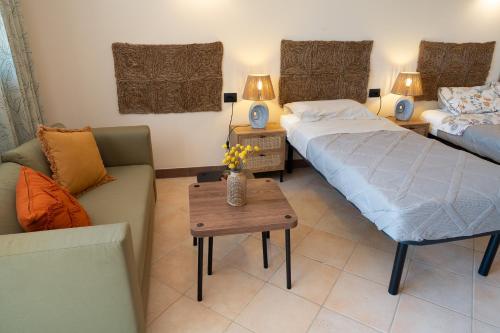 a living room with two beds and a couch at Agriturismo Casa del Vento in San Presto