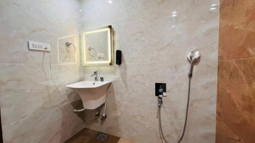 a bathroom with a sink and a shower at THE COMFORT Inn in Faizābād