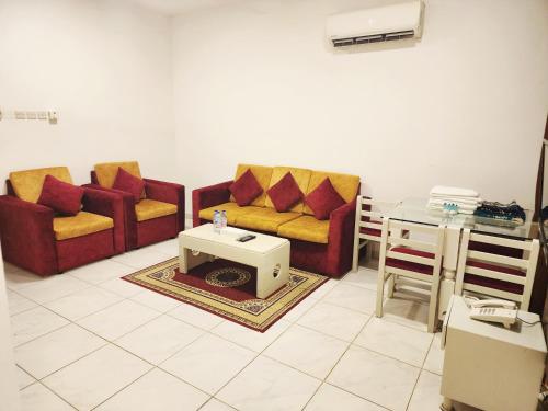 a living room with two couches and a table at Star Emirates Inn Hotel Salalah in Salalah
