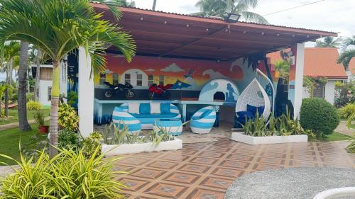 a building with a mural of surfboards on it at Galaxy Villa room in Dalaguete