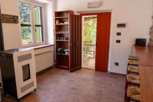 a living room with a red door and a window at Agriturismo Casa del Vento in San Presto