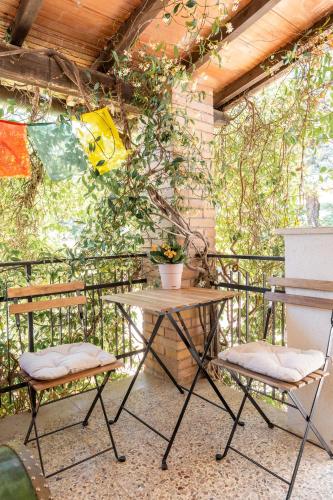 a patio with two chairs and a table at Agriturismo Casa del Vento in San Presto