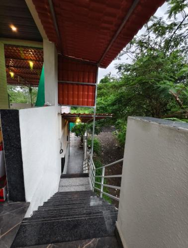 a stairway leading up to a building with a porch at AM2PM Private Pool Villa in Badlapur