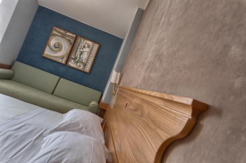 a small bedroom with a bed and a painting on the wall at BV Grand Hotel Assisi in Assisi