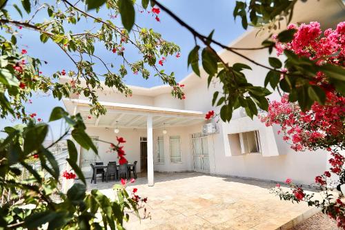 a view of the courtyard of a house with pink flowers at פרדייז ריזורט in Had Nes