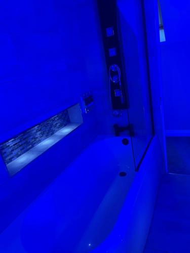 a bathroom with blue lights in a room at The hidden barn in Easington