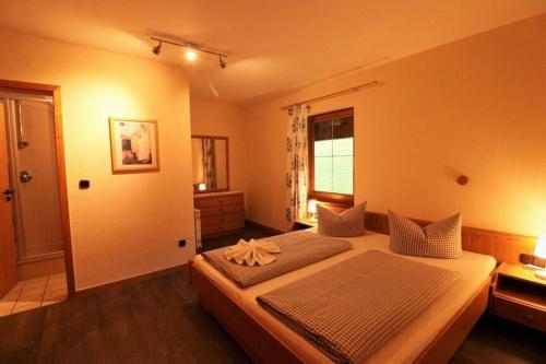 a bedroom with a bed and a window at Hotel Edelsberg in Untergschwend