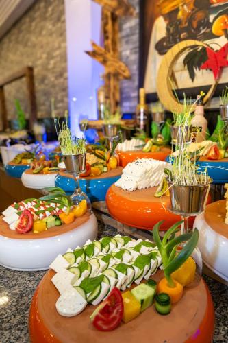 a bunch of plates of food on a table at Senza Sunset Beach Hotel in Alanya