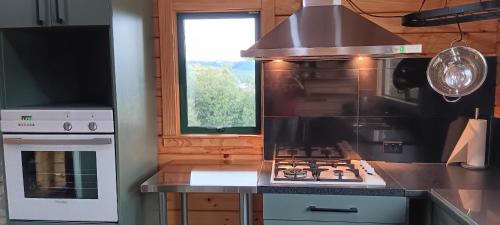 a kitchen with a stove and a stove top oven at Murrells Manapouri Lookout in Manapouri