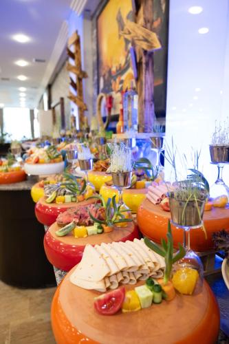 a row of plates of food on a table at Senza Sunset Beach Hotel in Alanya