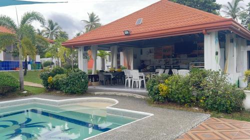 a house with a swimming pool in the yard at Galaxy Villa room in Dalaguete