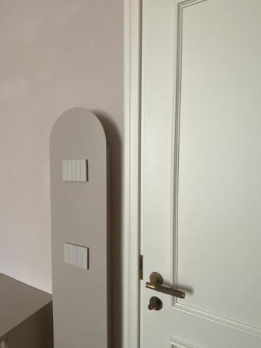 a white door with a metal handle next to it at Villino Bavassano - Dimora Storica in Rimini