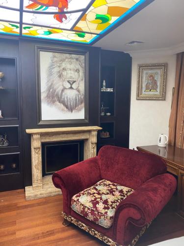 a living room with a couch and a painting of a lion at Bortnichi House in Kyiv