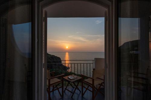 a view of the sunset from the balcony of a house at Hotel Punta Scario in Malfa