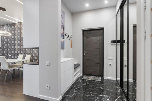 a bathroom with a black door and a table at Sea Pearl 1Line in Odesa