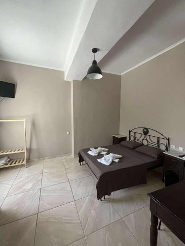 a room with a bed and a table in it at lacasadirigas in Lefkada